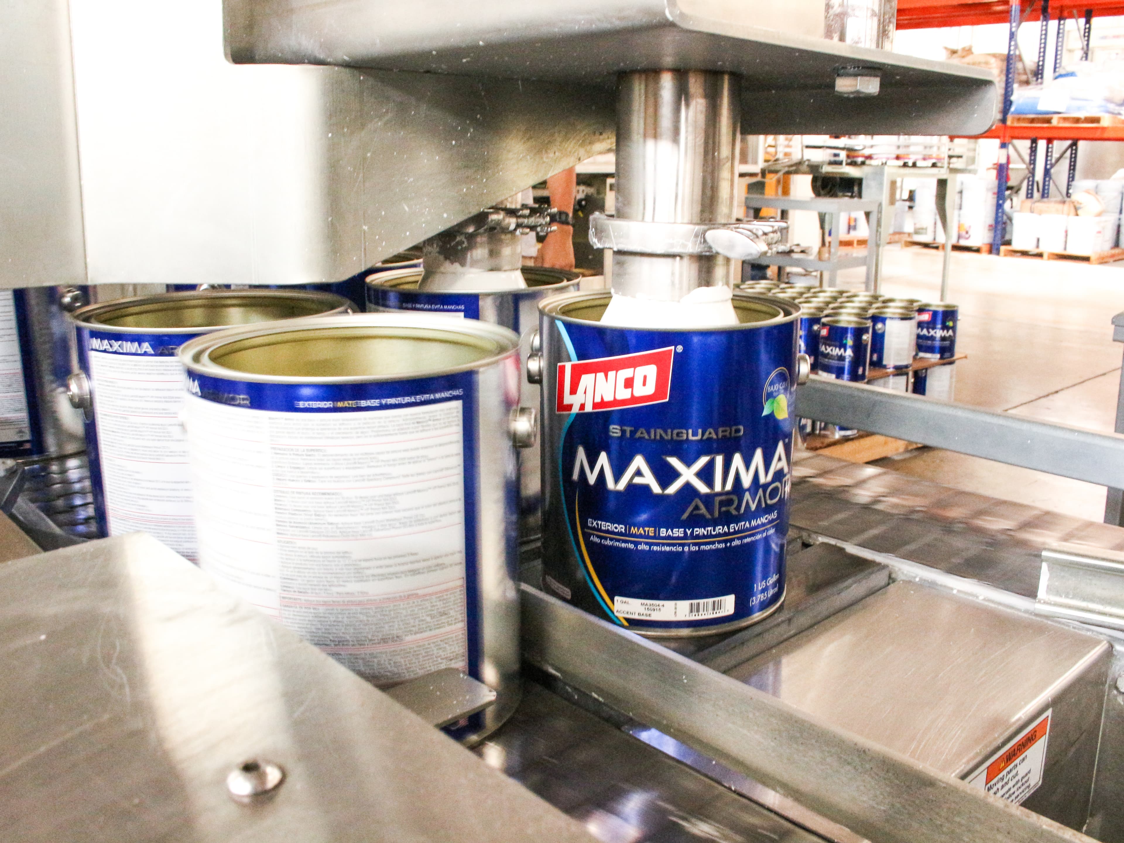Lanco Maxima Armor paint cans on production line